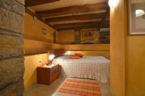 a bedroom with a bed and a stone wall at Bella Vista Apartments in Motovun