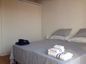 um quarto com uma cama com toalhas em La Casa Blanca y Azul em SantʼAntìoco