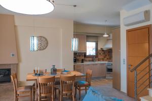 a kitchen with a table and chairs and a dining room at Saint Paul's Residences in Sani Beach