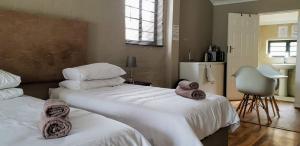 a bedroom with two beds with towels on them at 9 on Drommedaris in Stellenbosch