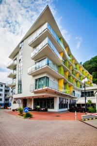 a large white building with colorful balconies at Wellness Hotel Panorama in Trenčianske Teplice