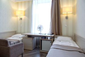 a room with two beds and a desk with a mirror at RA Nevsky 44 in Saint Petersburg