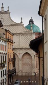 a large building with a green dome on a street at Residenza Vescovado in Vicenza