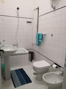 bagno bianco con lavandino e servizi igienici di Villa Preziosa a Portici