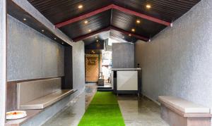 a hallway with a green floor in a building at Treebo Trend Malhaar Regency in Pune