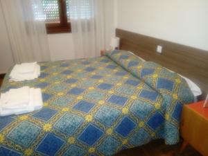 Voodi või voodid majutusasutuse Albergo alla Pineta toas