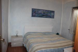 מיטה או מיטות בחדר ב-Appartamento Tella