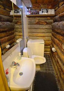 a bathroom with a white toilet and a sink at Salmikangas G4 in Ruka +10 photos