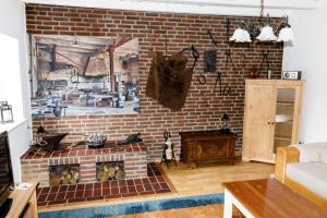 a living room with a brick wall with a fireplace at "Alte Schmiede" in Nordenham