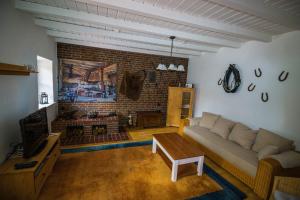 a living room with a couch and a brick wall at "Alte Schmiede" in Nordenham