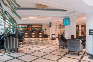 a lobby of a hotel with people sitting in chairs at Golden Tulip Addis Ababa in Addis Ababa