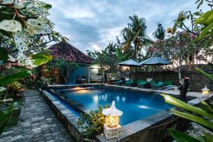 a pool at a villa with a resort at D and B Bungalow's by DeWizZ Management in Nusa Lembongan