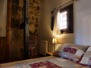 a bedroom with a bed with a quilt on it at El torreón in Albarracín