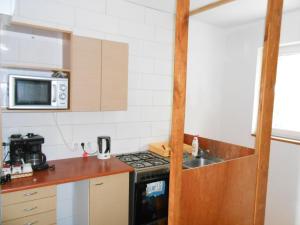a small kitchen with a stove and a sink at Baza Ck in Giżycko