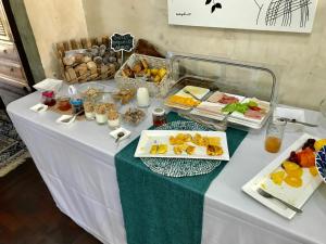 a table with a buffet of food on it at Acacia Inn GuestHouse in Maputo
