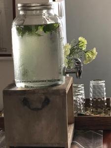 a drink in a jar on top of a table at Acacia Inn GuestHouse in Maputo