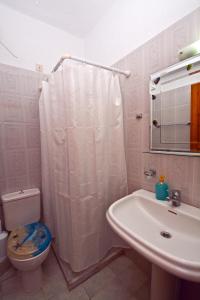 a bathroom with a toilet and a sink at Korinas House in Agnontas