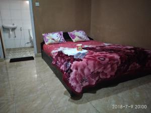 a bedroom with a bed with a table on it at Blue Mountain Cottage in Senaru