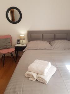 A bed or beds in a room at Apartments Karlo