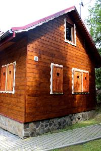 a wooden house with two doors and a window at Zawoja Chaty Górskie D2 in Zawoja