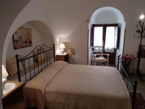 a bedroom with a bed and a table and a window at Agriturismo Zizzi in Ceglie Messapica