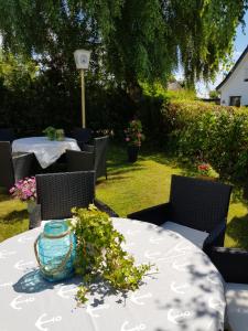 a table with a vase on top of it at Hotel Schleimünde in Kappeln