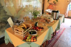 a table topped with lots of fruits and vegetables at Antica Pietrara B&B in Formello