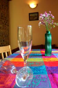 a table with two wine glasses and a vase of flowers at Zawoja Chaty Górskie D4 in Zawoja
