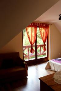 a bedroom with a bed and a large window at Zawoja Chaty Górskie D4 in Zawoja