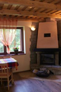 a living room with a brick fireplace and a table at Zawoja Chaty Górskie D4 in Zawoja