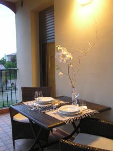 a dining room table with plates and glasses on it at Atelier in Portogruaro +22 photos