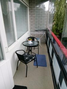 a small table and chairs on a balcony at Parantolankatu modern one room apartment in Hyvinkää