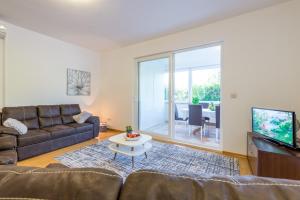 a living room with a couch and a table at Apartment Green Gold in Dubrovnik