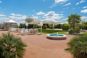 a patio with a fountain and chairs and a gazebo at Elba Madrid Alcalá in Madrid