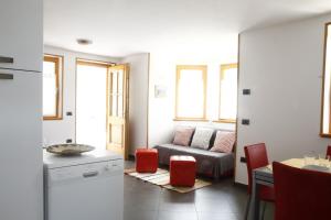 a living room with a couch and a table at Adamello Brenta Sunshine in Madonna di Campiglio