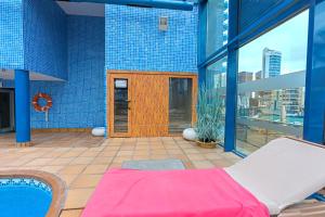 a room with a bed and a pool on a building at Hotel Madeira Centro in Benidorm