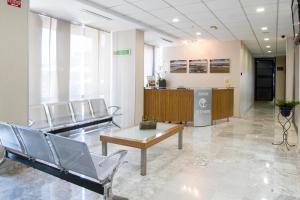 a waiting room in a hospital with chairs and a table at Hotel Madeira Centro in Benidorm