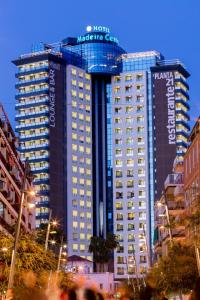 a tall building with a sign on top of it at Hotel Madeira Centro in Benidorm