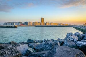 a view of a city with rocks in the water at #Kaaistraat2 in Ostend