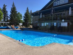 a large blue swimming pool in front of a building at Blue Mountain Studio Loft at North Creek Resort in Blue Mountains