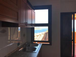 a window in a kitchen with a sink and a counter at Case Vacanza Mare Nostrum in Torre delle Stelle +112 photos