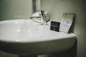 a book sitting on top of a bathroom sink at Hotel Nuro in Barbate +75 photos