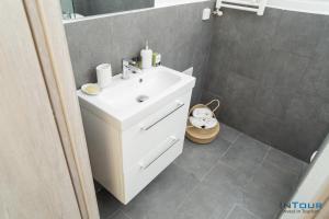 a bathroom with a white sink and a shower at Art point under Acropolis in Athens +17 photos