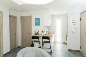a kitchen with a counter and two bar stools at Art point under Acropolis in Athens