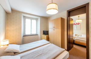 Rúm í herbergi á Albergo Ristorante Svizzero