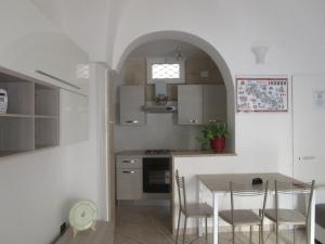 a kitchen with a table and chairs in a room at La dimora nel centro antico in Statte