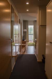a hallway with a door leading to a living room at Vierumäki Chalets 4414 in Vierumäki