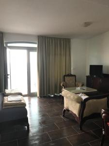 a living room with a couch and a table at Sunset View Apartments in Bar