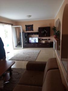 a living room with a couch and a flat screen tv at Komforna kuca Pale in Pale