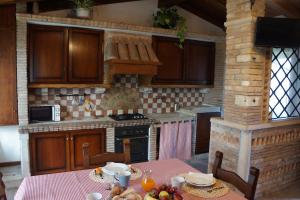 a kitchen with a table with food on it at Orange House La Brigata Apartments in Cavallino-Treporti